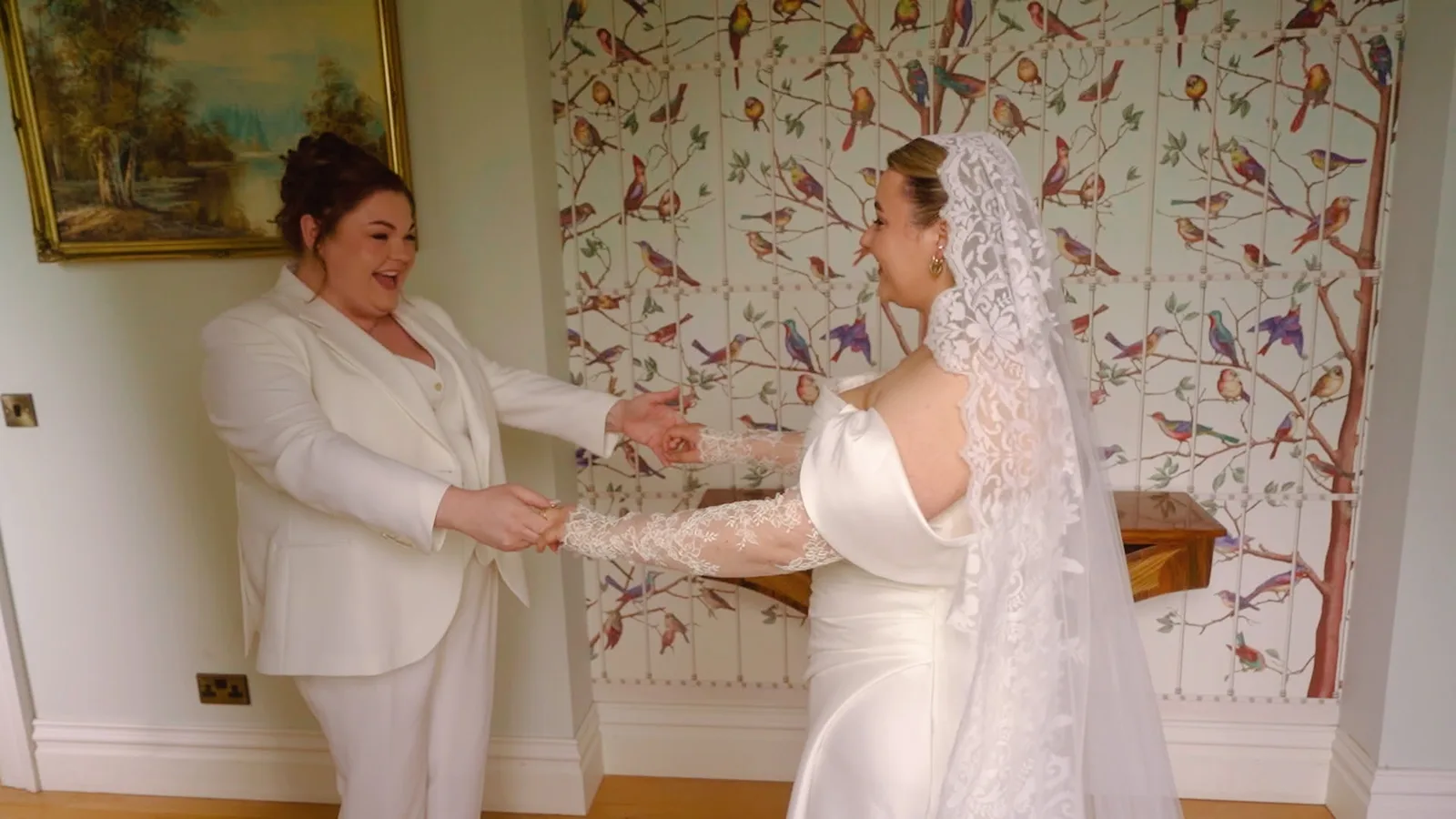 Two brides laughing during a natural, unposed first-look moment